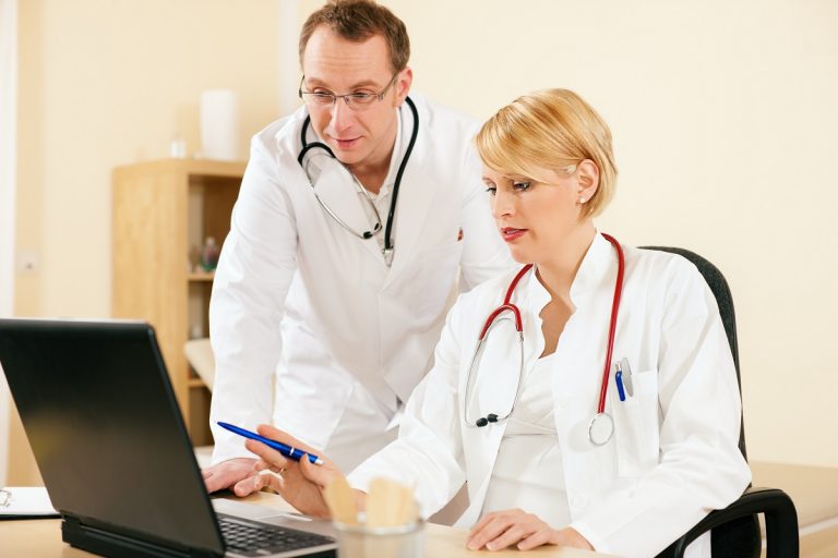 two doctors looking at a monitor