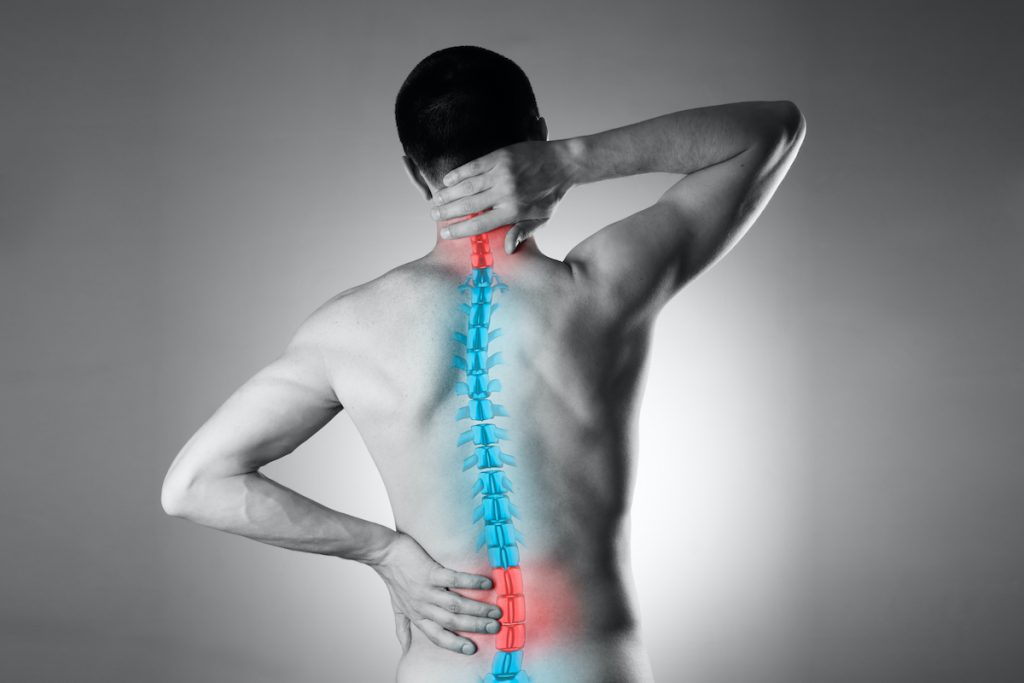 man experiencing neck and lower back pain