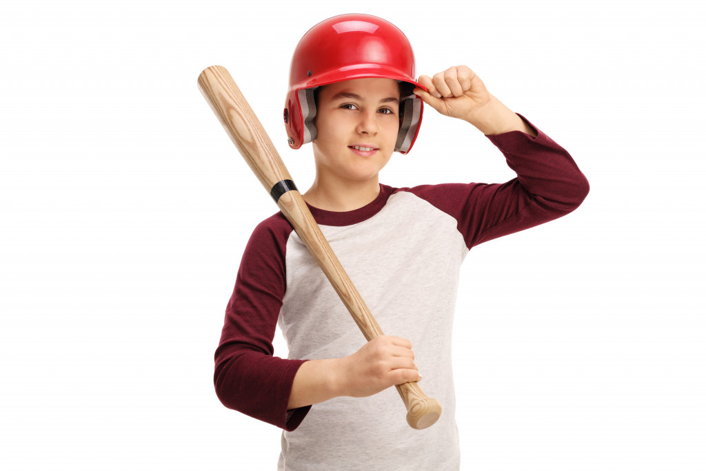 kid wearing a baseball helmet